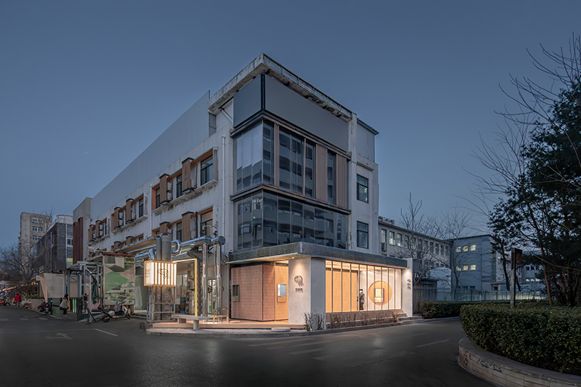 lantern-like lighting shines through suspended metal grid within tea pavilion in beijing