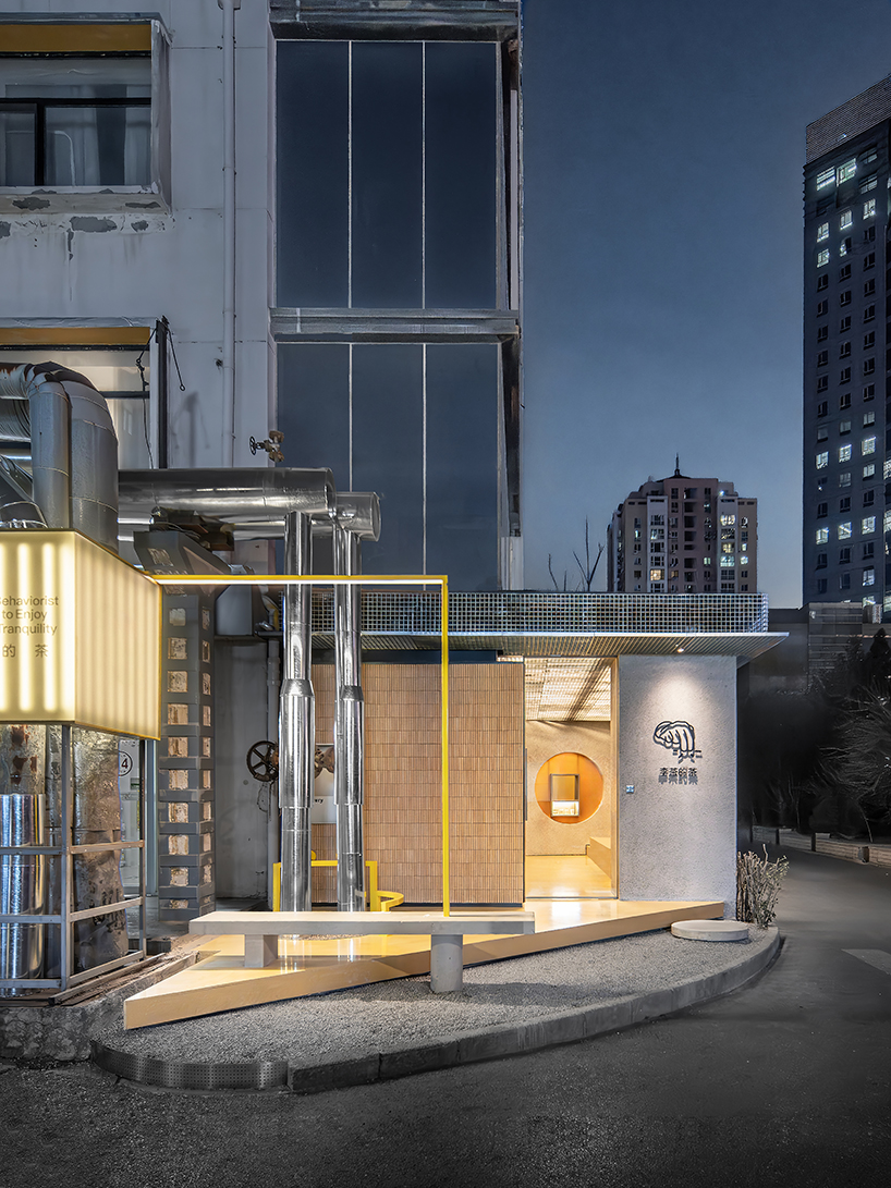 lantern-like lighting shines through suspended metal grid within tea pavilion in beijing