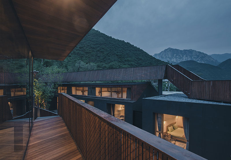 bending wooden bridge by DL atelier hovers above historical chinese fortress