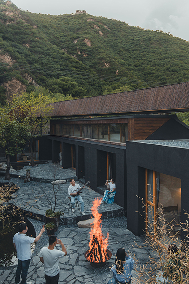 bending wooden bridge by DL atelier hovers above historical chinese fortress