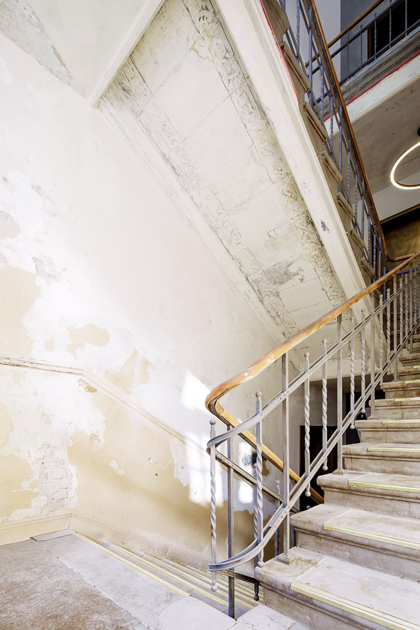 club marginal's renovation preserves the layers of time on historic office building in germany