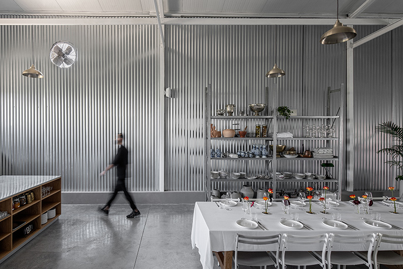 corrugated metal interiors reinvent vegetable storage fridge into industrial hospitality space