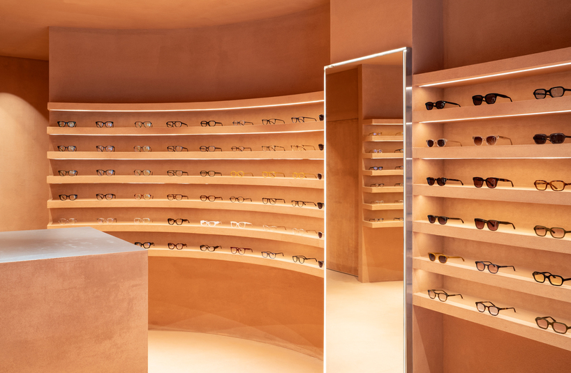 monochromatic terracotta interiors by el departamento adorn new optical boutique in spain