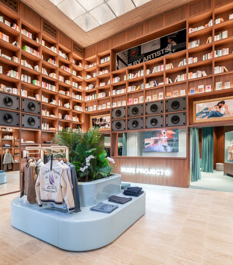 el departamento installs massive wooden bookshelf for nude project's new store in barcelona