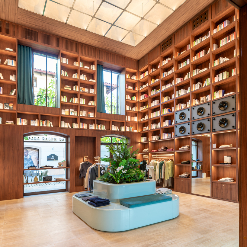 el departamento installs massive wooden bookshelf for nude project's new store in barcelona