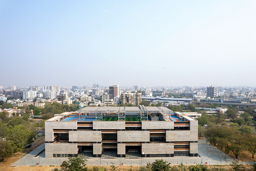 playfully stacked geometric concrete volumes compose student facility in india