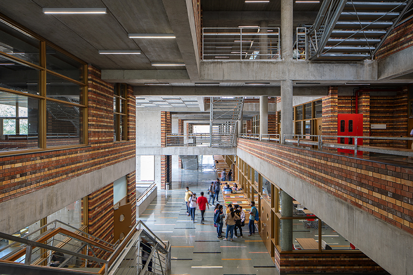 playfully stacked geometric concrete volumes compose student facility in india