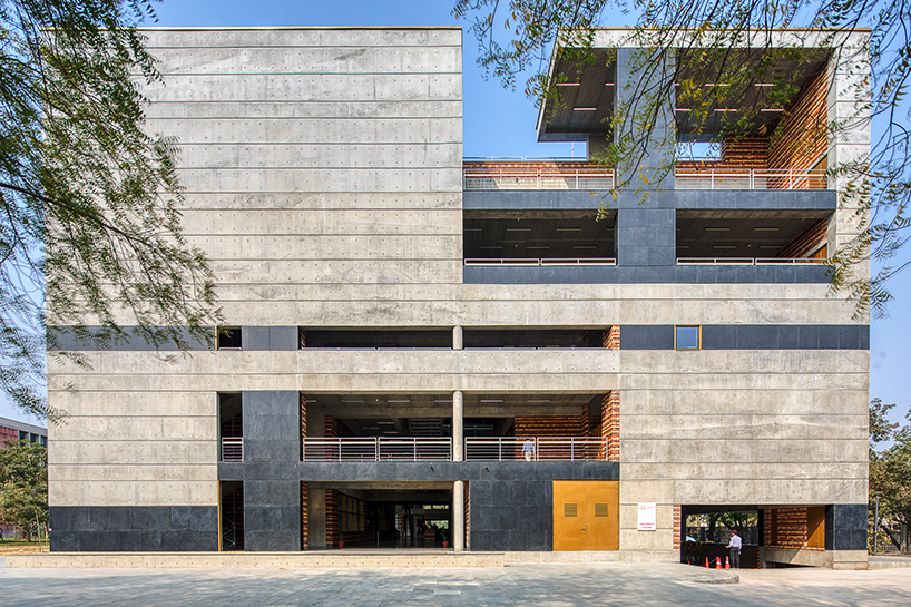playfully stacked geometric concrete volumes compose student facility in india