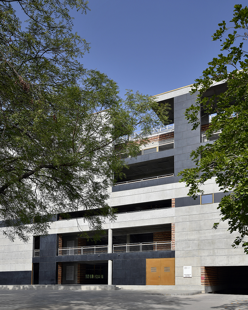 playfully stacked geometric concrete volumes compose student facility in india