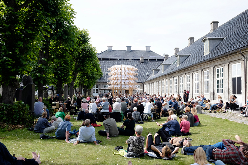 kinetic pavilion of wooden deck chairs by lasovsky johansson 'blooms' in copenhagen