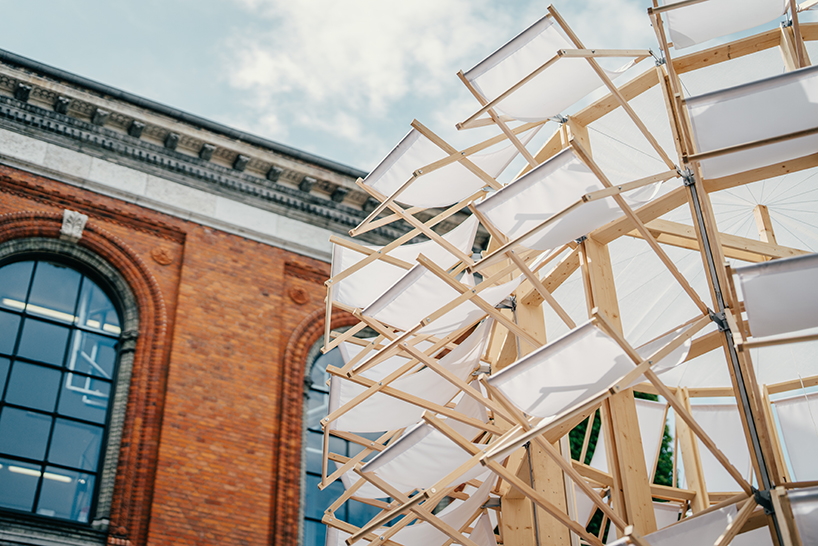 kinetic pavilion of wooden deck chairs by lasovsky johansson blooms in ...