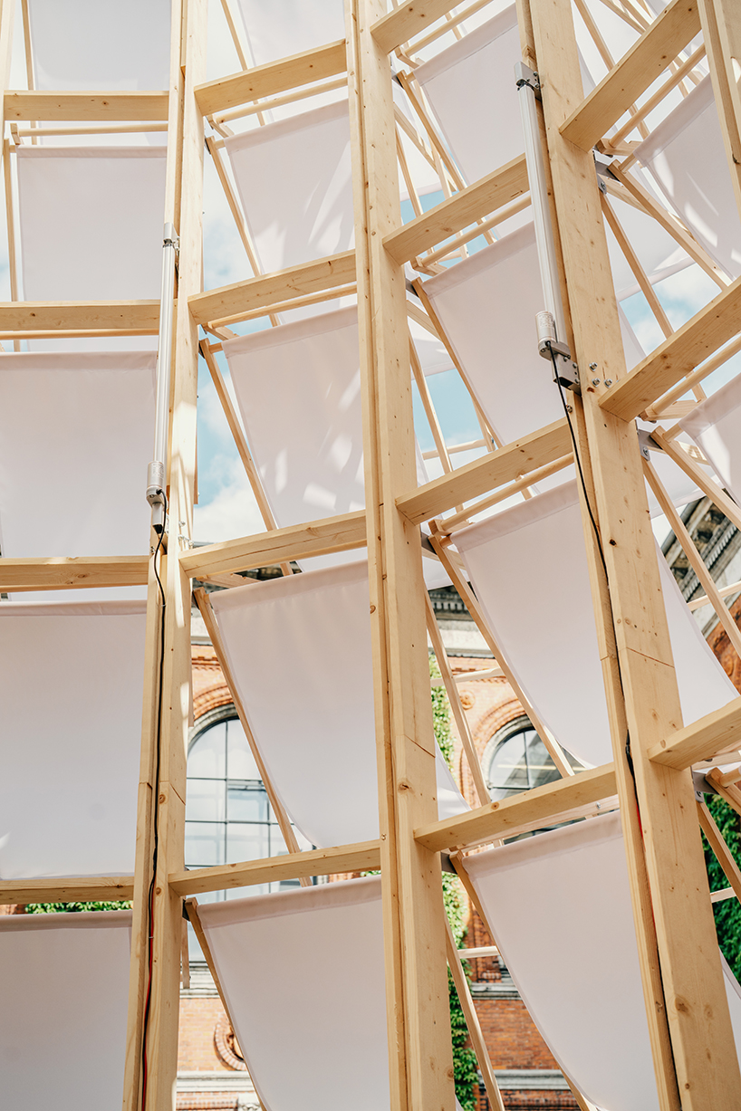 kinetic pavilion of wooden deck chairs by lasovsky johansson 'blooms' in copenhagen