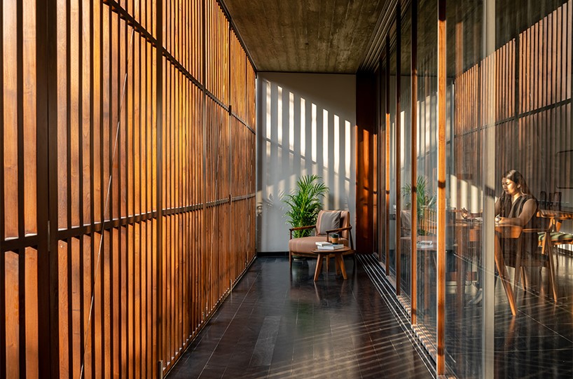 workspace in india showcases a material palette of wood, concrete, and kota stones
