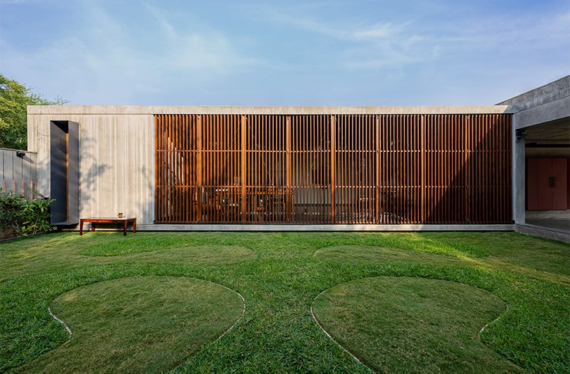 workspace in india showcases a material palette of wood, concrete, and kota stones