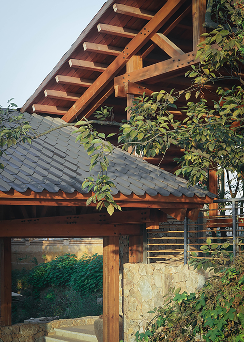 continuous gabled roof tops galaxy arch's wood-framed community space in chinese village