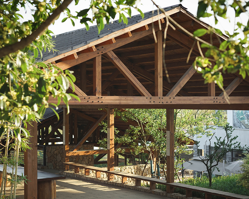 continuous gabled roof tops galaxy arch's wood-framed community space in chinese village