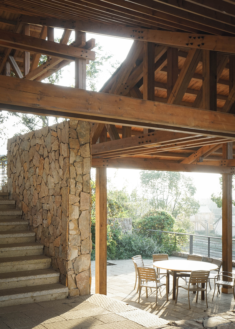 continuous gabled roof tops galaxy arch's wood-framed community space in chinese village