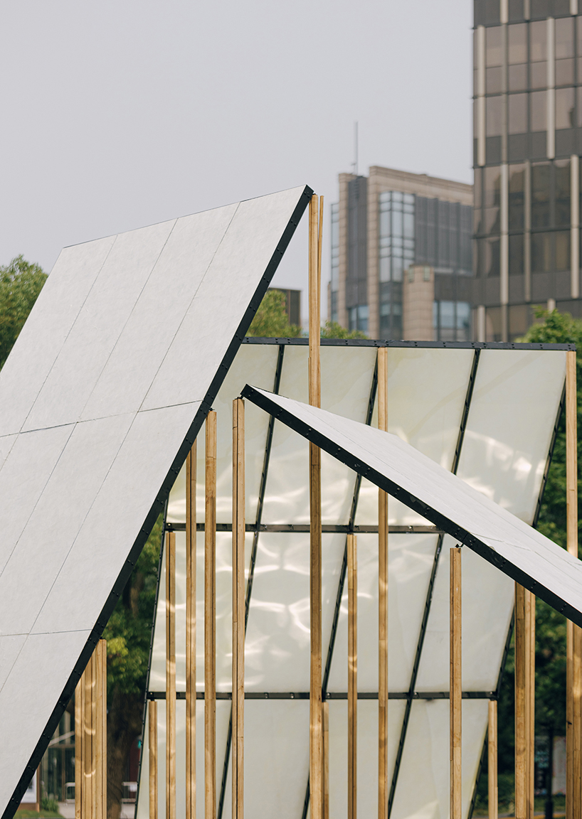 translucent panels of galaxy arch's installation cast warm glow across park in china