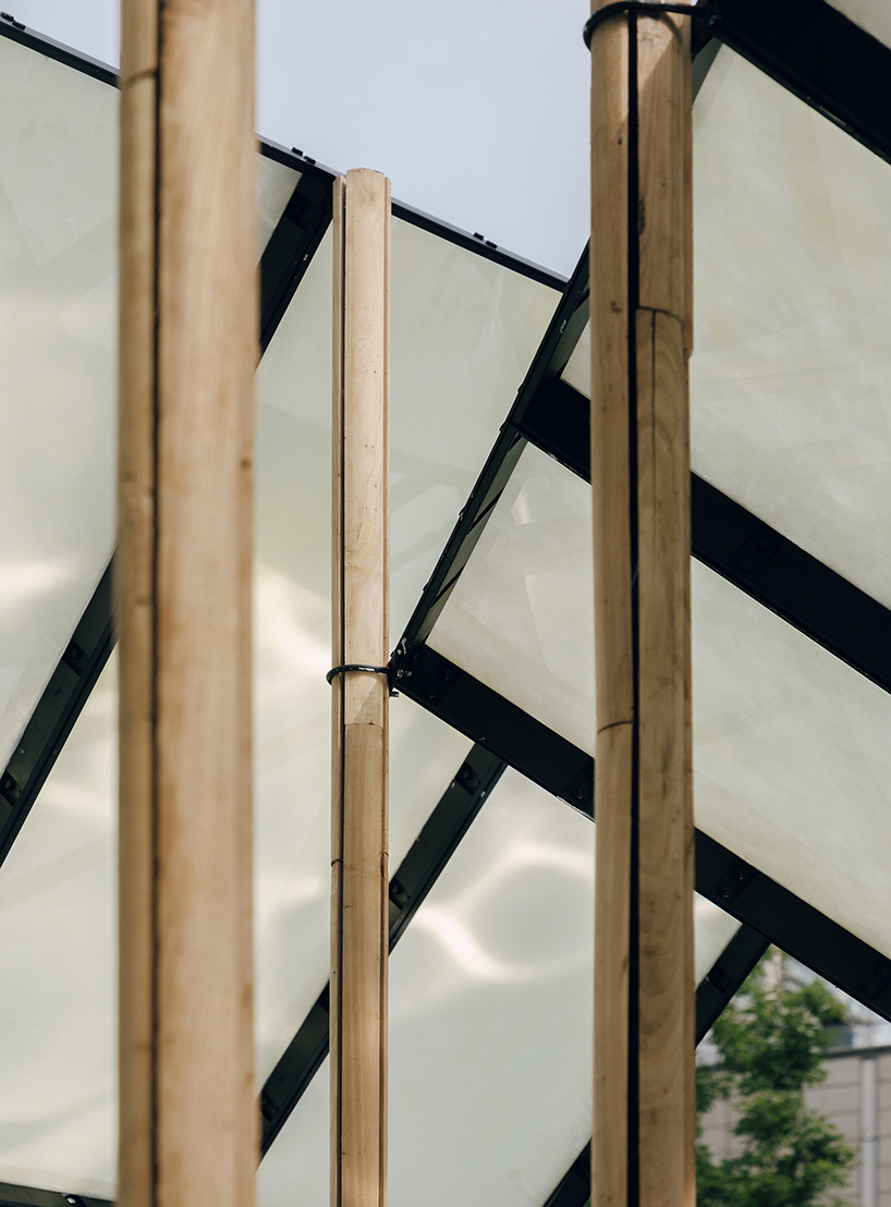translucent panels of galaxy arch's installation cast warm glow across park in china