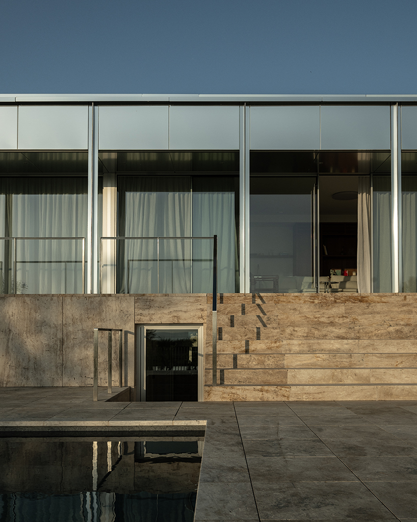 reflective aluminum framework crowns the clifftop house by KONTEXTUS in hungary