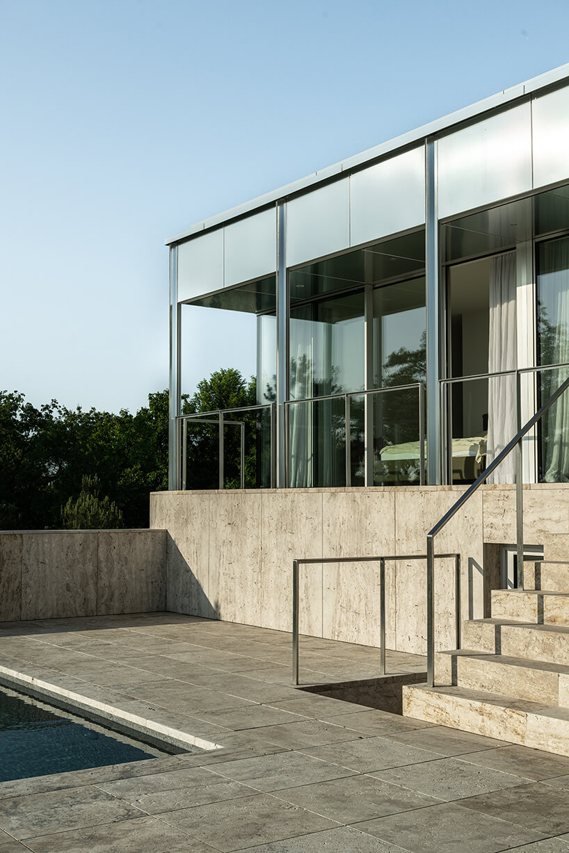 reflective aluminum framework crowns the clifftop house by KONTEXTUS in hungary