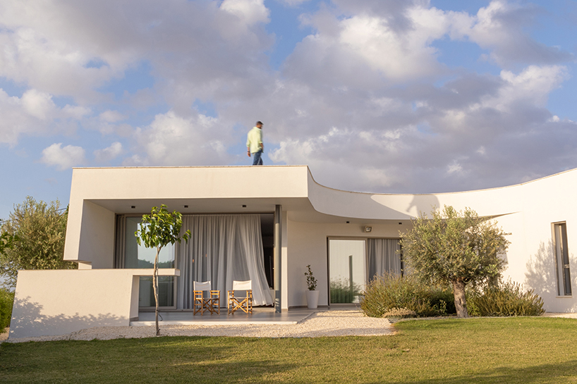 villa gel in cyprus outlines a curvilinear layout that fuses with the greenery