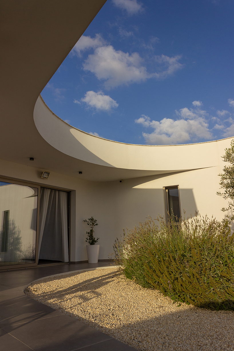 villa gel in cyprus outlines a curvilinear layout that fuses with the greenery