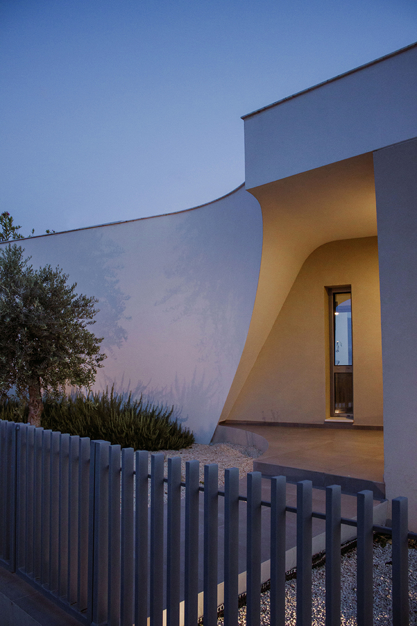 villa gel in cyprus outlines a curvilinear layout that fuses with the greenery