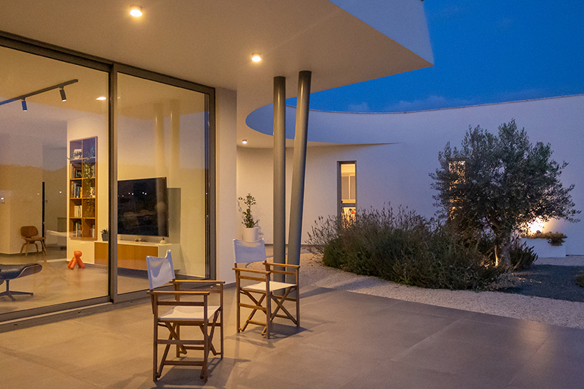 villa gel in cyprus outlines a curvilinear layout that fuses with the greenery