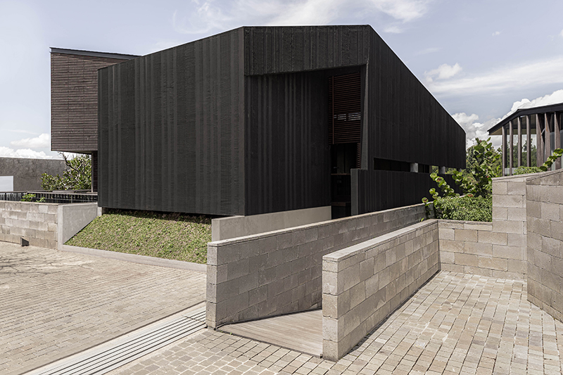 dark monolithic angular volumes shape jae haala villa in indonesia