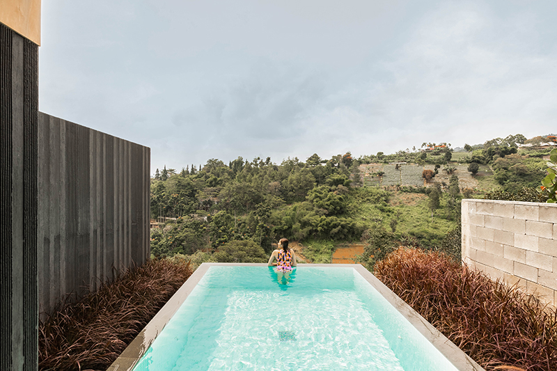 dark monolithic angular volumes shape jae haala villa in indonesia