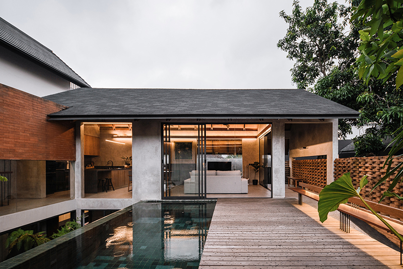 red brick lace-like facade coats the mass of ach house in south jakarta