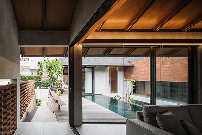 red brick lace-like facade coats the mass of ach house in south jakarta