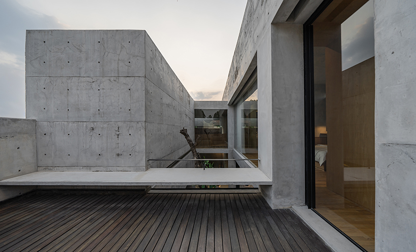 Exposed concrete and brick form the facade of YSH House in Central Java