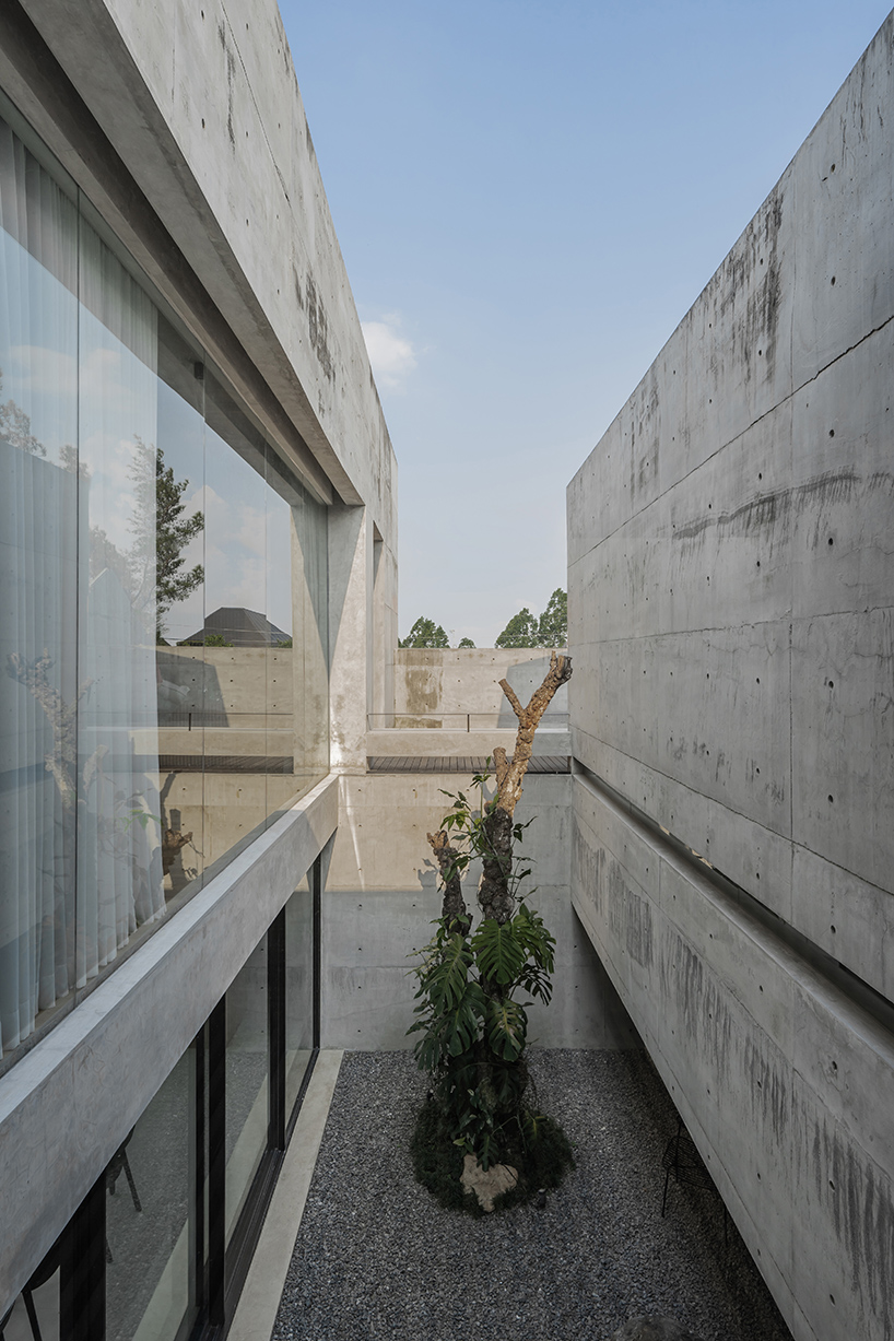 Exposed concrete and brick form the facade of YSH House in Central Java