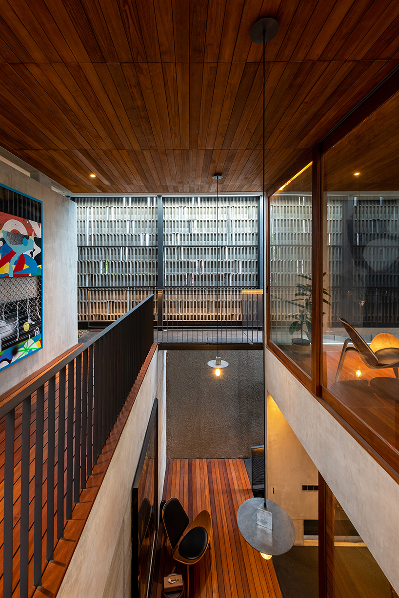 concrete breezeblocks clad residence's facade by wiyoga nurdiansyah architects