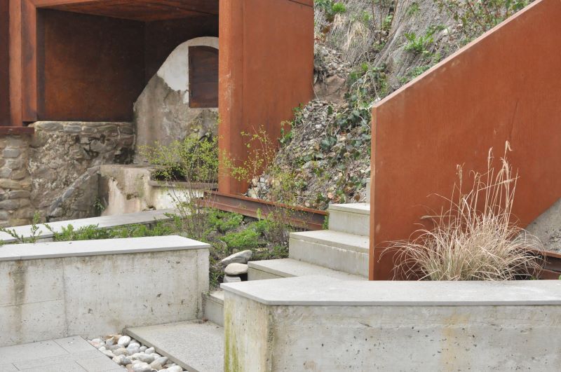 corten steel and stone components revamp collapsed open washhouse in italy