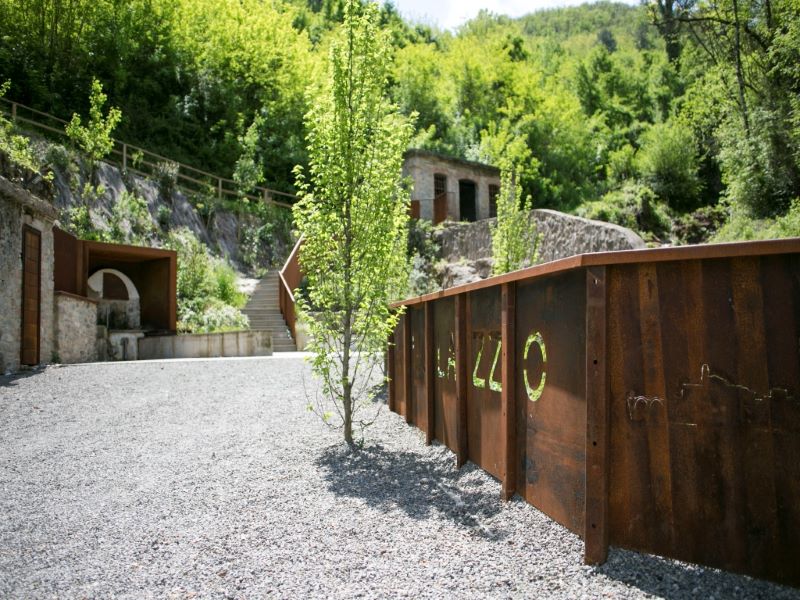 corten steel and stone components revamp collapsed open washhouse in italy