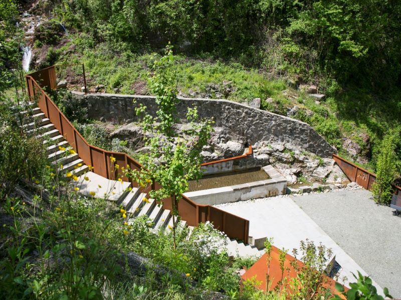 corten steel and stone components revamp collapsed open washhouse in italy