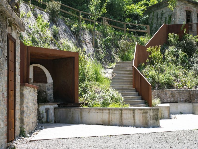 corten steel and stone components revamp collapsed open washhouse in italy