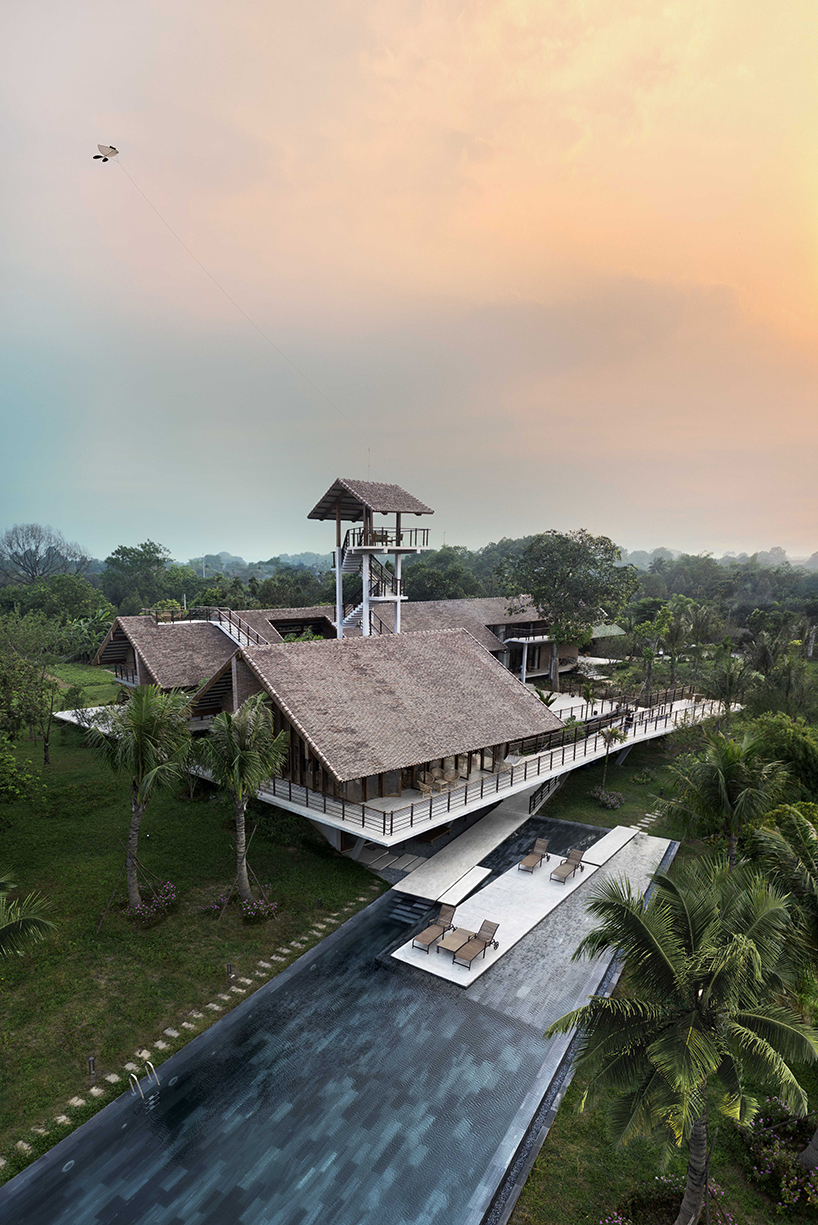 raised CHP getaway house stands on stilts above sloping terrain in vietnam