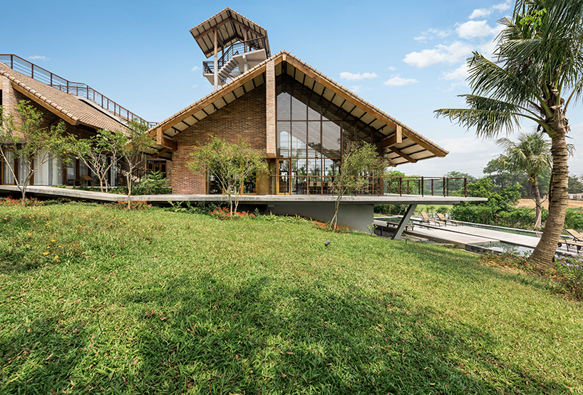 raised CHP getaway house stands on stilts above sloping terrain in vietnam