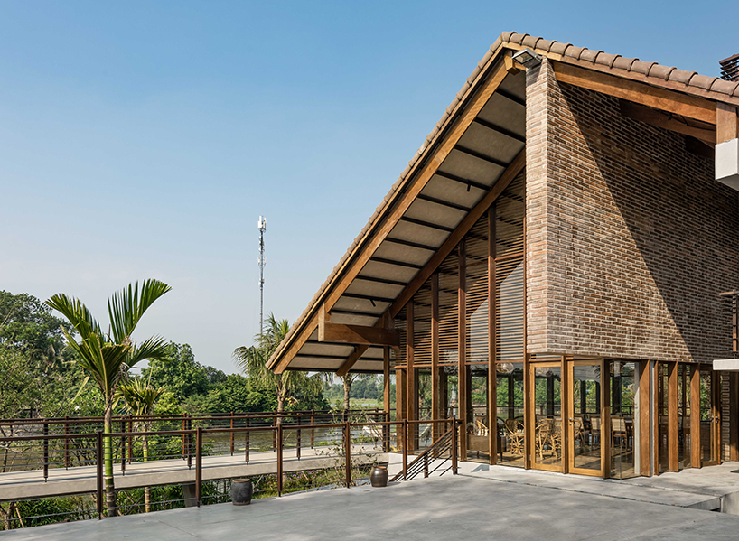 raised CHP getaway house stands on stilts above sloping terrain in vietnam