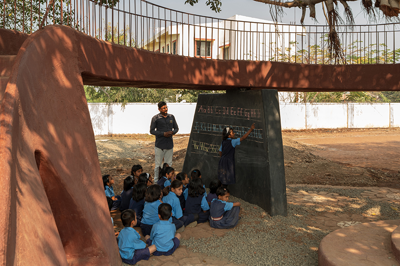 pod for happiness sculpts curving play area around banyan tree in indian school campus