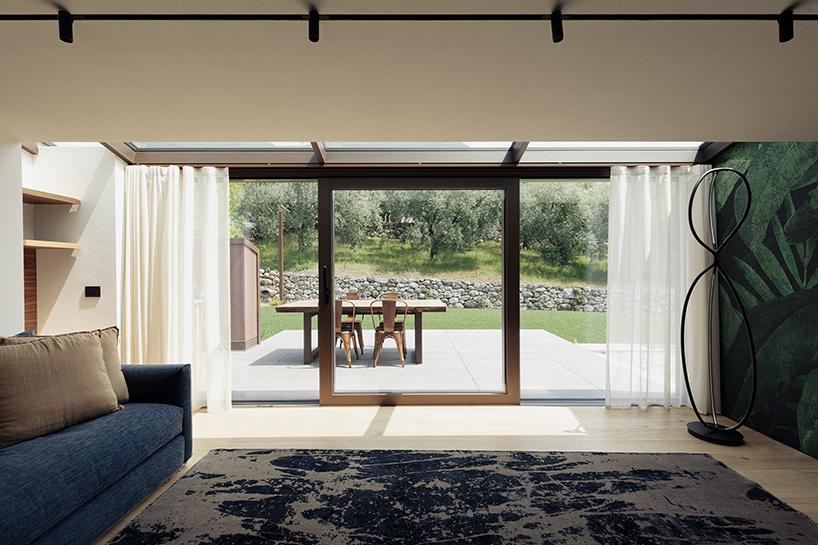 stone walls and warm wooden features adorn private residence in northern italy