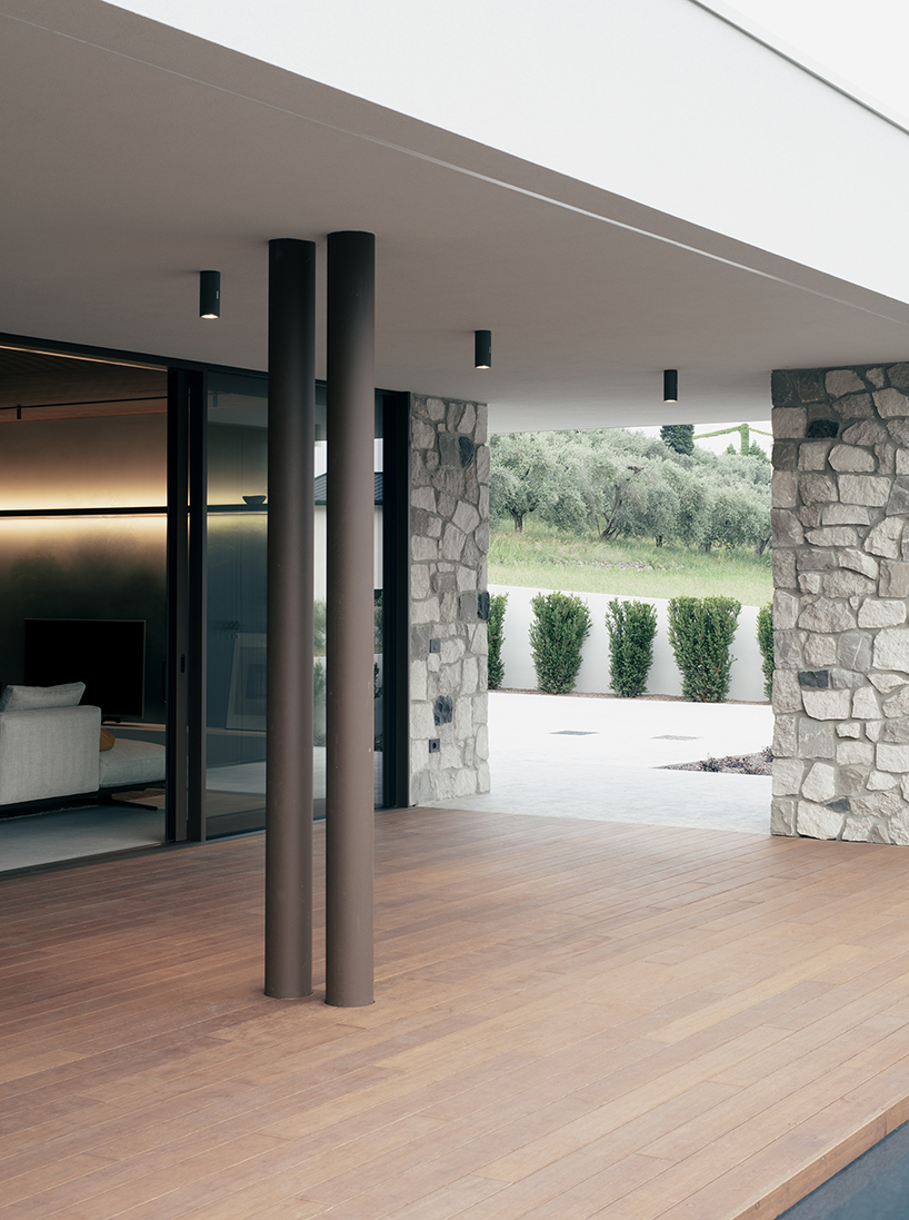 stone walls and warm wooden features adorn private residence in northern italy