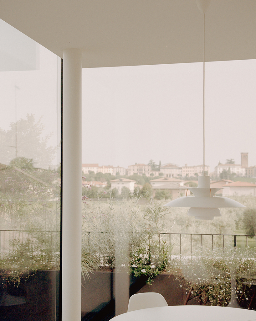 exposed concrete volumes and sliding wooden shutters compose house nf in italy