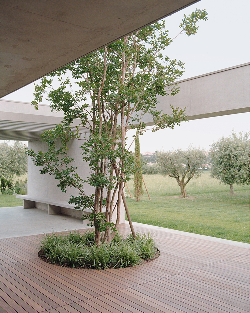exposed concrete volumes and sliding wooden shutters compose house nf in italy