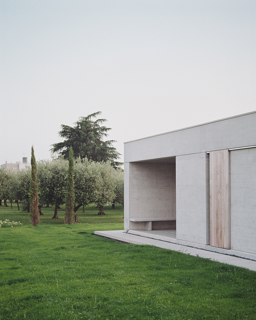 exposed concrete volumes and sliding wooden shutters compose Didonè Comacchio Architects' house nf in italy