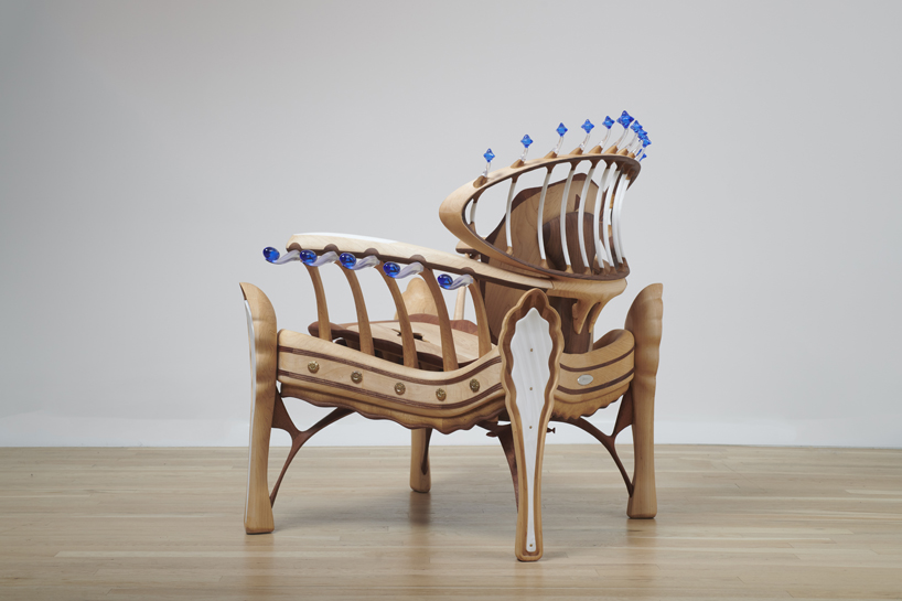 cosmos chair's peculiar design reflects our universe through wooden halos and glass stars